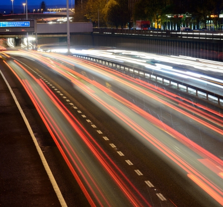Streaks of coloured light from vehicles travelling during a winter rush hour on the M8 motorway in Glasgow.