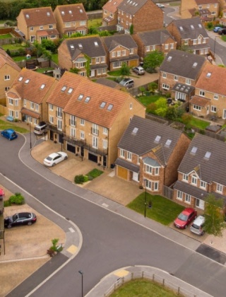 Aerial view of a new housing estate with detached and semi detached houses.