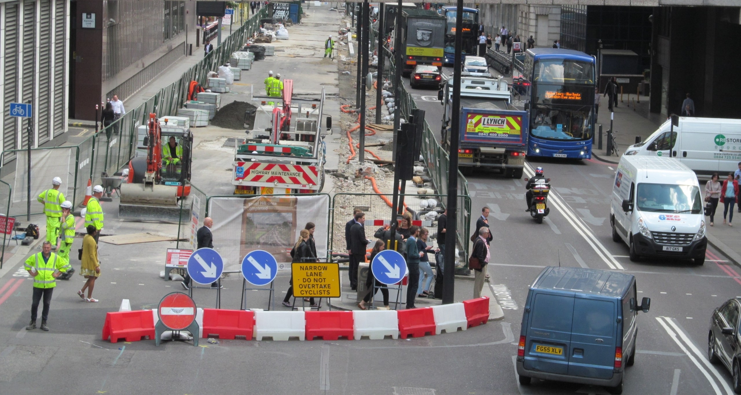New road roadworks pedestrians cars in London traffic.