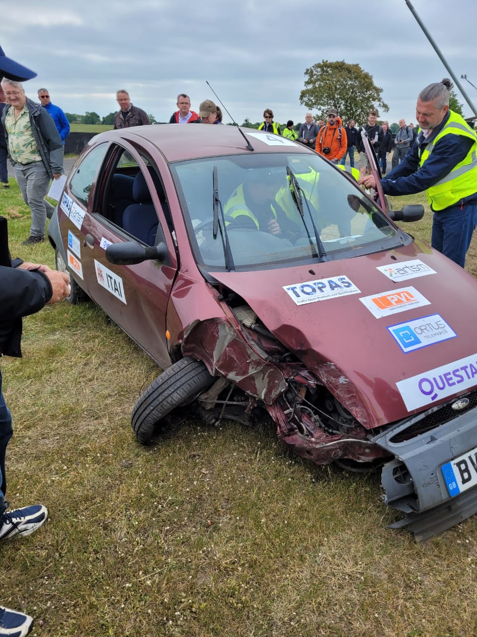Crash test red car front end damage