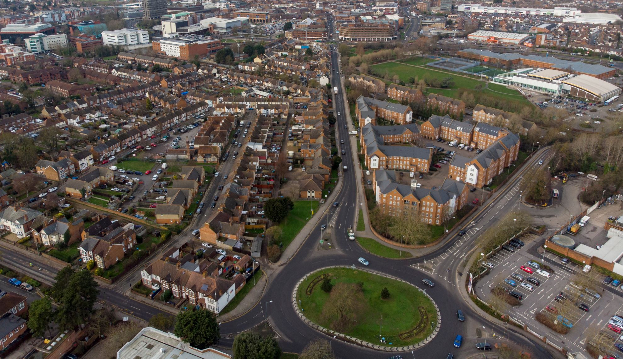 Aerial view of a housing estate and industrial buildings in a city centre.