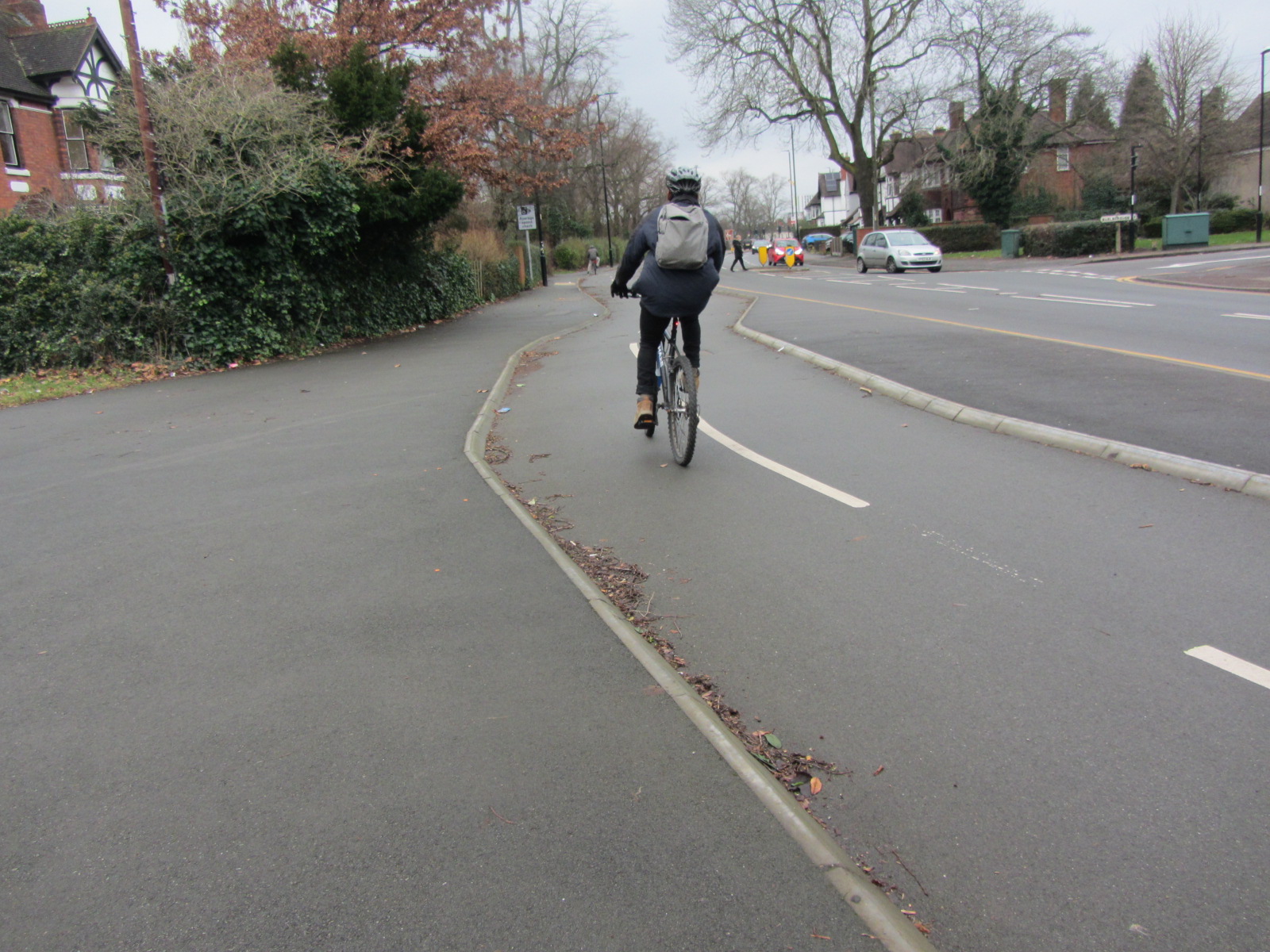 A person riding a bike on a cycle way.