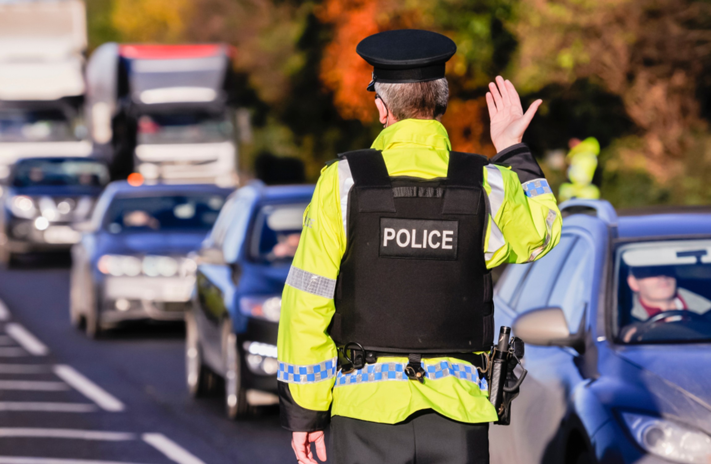 Police man signalling on going traffic.